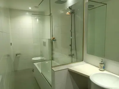 a white bathroom with a glass shower and a sink at Casa das Capelas in Villamarín