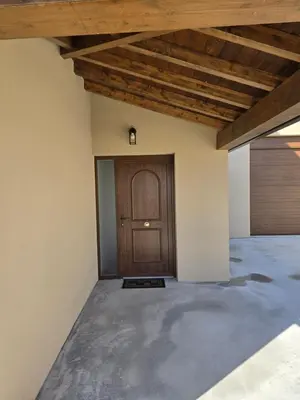 a room with a wooden door and a garage at A de Féliz Ribadeo in Ribadeo