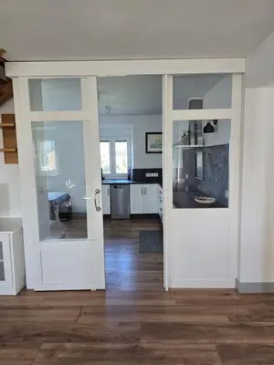 an open door in a room with a kitchen at A de Féliz Ribadeo in Ribadeo