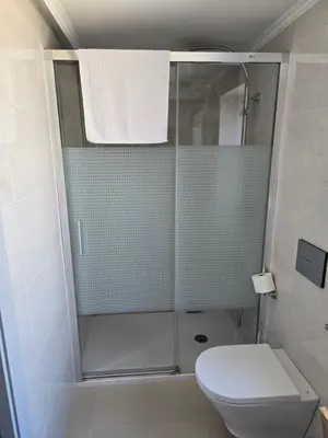 a bathroom with a shower and a toilet at A de Féliz Ribadeo in Ribadeo