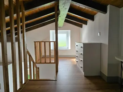 a room with a staircase and a dresser at A de Féliz Ribadeo in Ribadeo