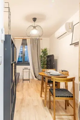 a dining room with a wooden table and a dining roomiasm at Maior 5 Apartamentos in Verín