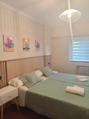 a bedroom with a green bed and a window at Casa andaina in Palas de Rei