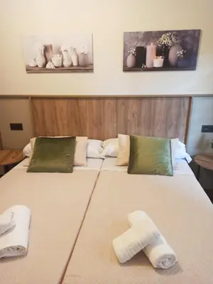 two towels on a bed in a room at Casa andaina in Palas de Rei
