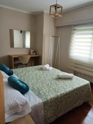 a bedroom with a bed with two pillows on it at Casa andaina in Palas de Rei
