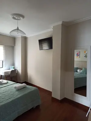 a bedroom with two beds and a mirror in it at Casa andaina in Palas de Rei