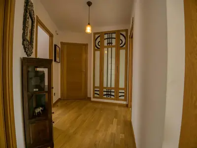 an empty living room with a door and wooden floors at Ático en Sada in Sada