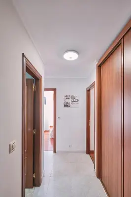 an empty hallway with wooden doors and a room at Peregrina Pensión 5 in O Pedrouzo