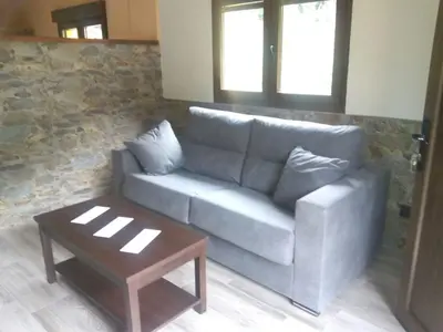 a living room with a couch and a coffee table at Apartamentos rurales La Veiga in La Riera