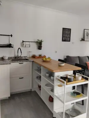 a kitchen with a wooden counter top and a sink at Campo da Torre in Caldas de Reis