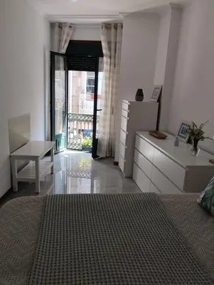 a bedroom with a bed and a desk and a window at Campo da Torre in Caldas de Reis
