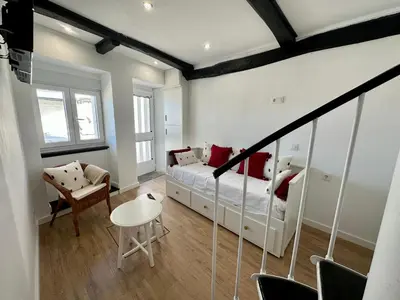 a bedroom with a bed and a table and chairs at N&E - Home Celanova Rúa Manuel Lezón in Celanova