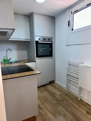 a kitchen with white cabinets and a sink and a window at N&E - Home Celanova Rúa Manuel Lezón in Celanova