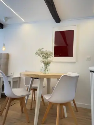 a dining room with a wooden table and white chairs at N&E - Home Celanova Rúa Manuel Lezón in Celanova
