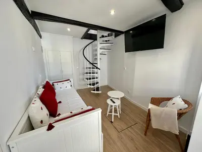 a small living room with a couch and a staircase at N&E - Home Celanova Rúa Manuel Lezón in Celanova
