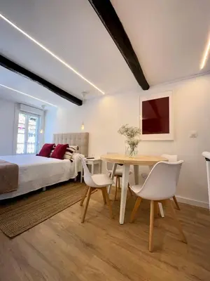 a bedroom with a bed and a table and chairs at N&E - Home Celanova Rúa Manuel Lezón in Celanova