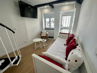 a bedroom with a bed with red and white pillows at N&E - Home Celanova Rúa Manuel Lezón in Celanova