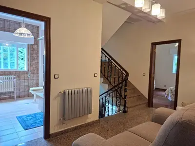 a hallway with a door to a room with windows at Oasis Ponte San Lázaro in Santiago de Compostela