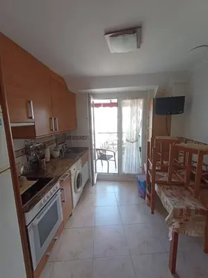 a kitchen with a sink and a stove top oven at Apartamento de vacaciones in Ribadeo