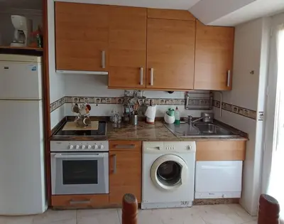 a kitchen with a washing machine and a dishwasher at Apartamento de vacaciones in Ribadeo