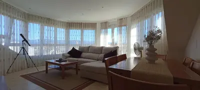 a living room with a couch and a table at Apartamento de vacaciones in Ribadeo