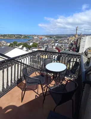 a table and chairs on a balcony with a view at Apartamento de vacaciones in Ribadeo