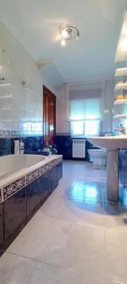 a large kitchen with a large tub and a table at Apartamento en las afueras in Ribadeo
