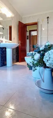 a room with vases of flowers and a table at Apartamento en las afueras in Ribadeo