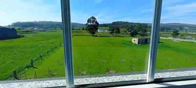 a view of a field from a window at Apartamento en las afueras in Ribadeo