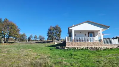 a small house in a field with a blue sky at “Casa abella “ in Monterrei