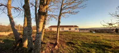 a house in the middle of a field with trees at “Casa abella “ in Monterrei