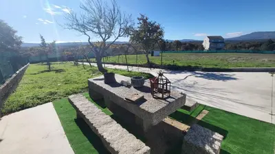 a view of a park with a tree and grass at “Casa abella “ in Monterrei