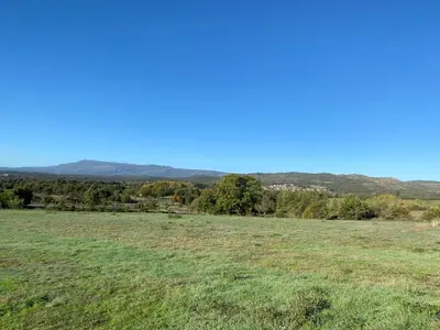 a field of grass with mountains in the background at “Casa abella “ in Monterrei