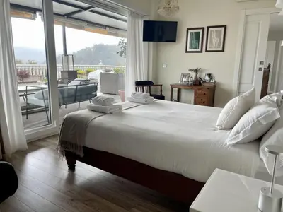 a bedroom with a large bed and a balcony at Casa Acougo, Sarria in Sarria