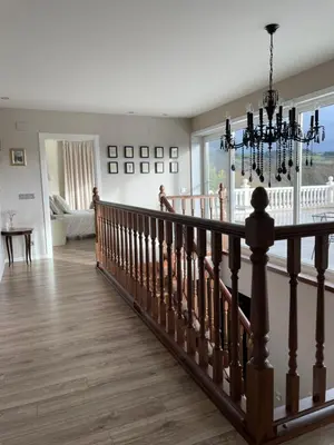 a staircase in a home with a chandelier at Casa Acougo, Sarria in Sarria