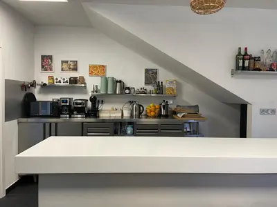 a kitchen with a white counter top in a room at Casa Acougo, Sarria in Sarria