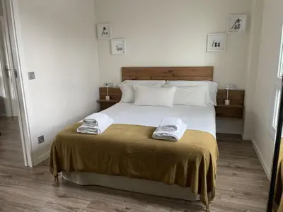 a bedroom with a bed with two towels on it at Casa Acougo, Sarria in Sarria