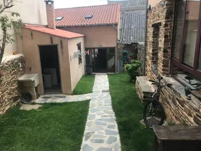 a bike parked in a yard next to a building at Albergue Gabino in El Ganso