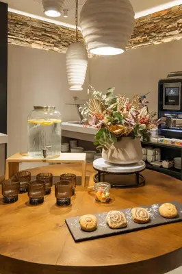 a kitchen with a table with donuts on it at Sercotel EsteOeste in Lugo