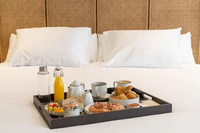a tray of breakfast food on a bed at Sercotel EsteOeste in Lugo