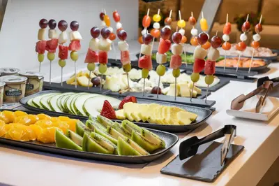 a buffet with many different types of fruit on trays at Sercotel EsteOeste in Lugo