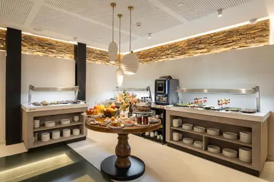 a restaurant with a table with food on it at Sercotel EsteOeste in Lugo