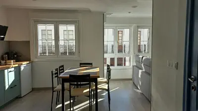 a kitchen and dining room with a table and chairs at Lar ABEANCOS in Melide