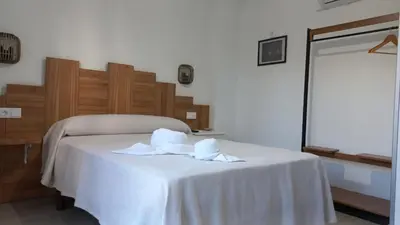 a room with a bed with towels on it at Lar ABEANCOS in Melide