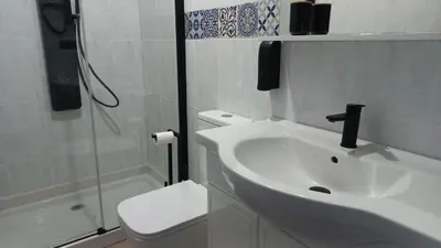 a bathroom with a sink and a toilet and a shower at Lar ABEANCOS in Melide