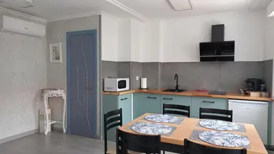 a kitchen with a table and chairs in a room at Lar ABEANCOS in Melide
