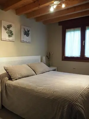 a bedroom with a large bed in a room at Casa AsCampinas in Ourense