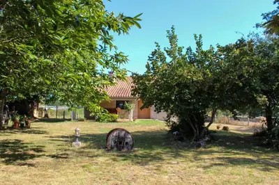 a house with a fire hydrant in the yard at Casa AsCampinas in Ourense