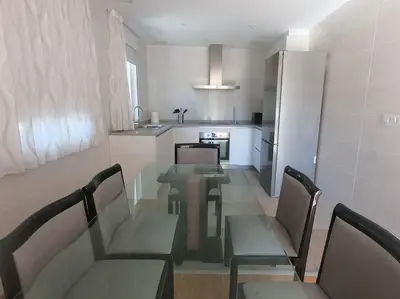 a room with a table and chairs in a kitchen at PENSION BOUTIQUE TEIXEIRA, 3 ESTRELLAS in La Teijeira
