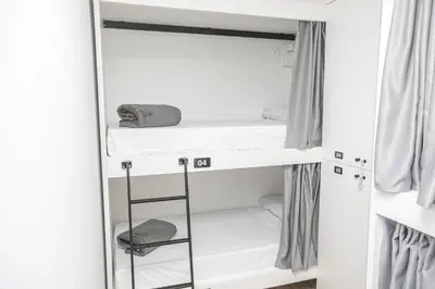 a closet with white walls and white shelves at Albergue A Fabrica in Santiago de Compostela